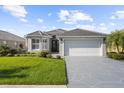 One-story home with gray driveway and landscaping at 5207 Pine Shadow Ln, North Port, FL 34287