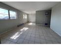 Bright living room featuring tile flooring, windows and modern light fixture at 21288 Edgewater Dr, Port Charlotte, FL 33952