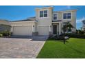 Inviting two-story home featuring a paved driveway, a two-car garage, and manicured landscaping at 4322 Silo Port Ct, Lakewood Ranch, FL 34211