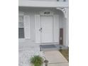 Close-up view of the front door with a welcome sign and decorative lighting, enhancing curb appeal at 4629 Sabal Key Dr # 4629, Bradenton, FL 34203