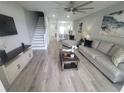 Spacious living room with modern flooring, stylish furniture, and a staircase, creating an inviting atmosphere at 4629 Sabal Key Dr # 4629, Bradenton, FL 34203