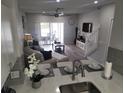 Open-concept living space with sliding glass doors to a patio, visible from the kitchen counter at 4629 Sabal Key Dr # 4629, Bradenton, FL 34203
