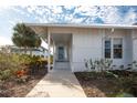 Inviting front porch with white columns and freshly landscaped yard, perfect for relaxing at 835 Audubon Dr # 835, Bradenton, FL 34209