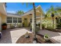 Private courtyard entry with brick pavers and lush landscaping at 1922 Field Rd, Sarasota, FL 34231