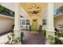 Inviting entryway with a bright yellow door and a covered porch at 1922 Field Rd, Sarasota, FL 34231