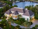 Luxury home with a circular driveway and lush landscaping at 501 Harbor Point Rd, Longboat Key, FL 34228