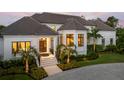 Elegant home exterior with a grand entrance and landscaping at 501 Harbor Point Rd, Longboat Key, FL 34228