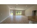 Spacious living room with recessed lighting, a large window, and wood-look tile flooring at 2132 Nordendale Blvd, North Port, FL 34288