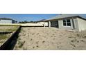 Spacious backyard with a view of the home's covered patio, ready for landscaping and outdoor enjoyment at 766 Hillshire Pl, Spring Hill, FL 34609