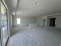 Bright, open-concept living room featuring large windows for natural light and ample space for customization at 766 Hillshire Pl, Spring Hill, FL 34609