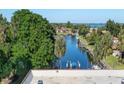 Scenic view of a peaceful waterway with lush greenery and docked boats at 9612 Valencia Cv, Bradenton, FL 34210
