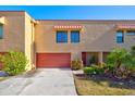 Tan colored condo building with red garage door at 4013 Catalina Dr # 4013, Bradenton, FL 34210