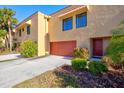 Tan colored condo building with red garage door at 4013 Catalina Dr # 4013, Bradenton, FL 34210