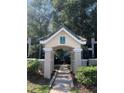 Building entrance with a covered walkway and well-maintained landscaping at 5152 Northridge Rd # 302, Sarasota, FL 34238