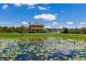 House with a pond and lush vegetation in front at 7301 221St E St, Bradenton, FL 34211