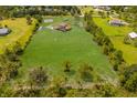 Aerial view of a house with a large lawn and pond at 7301 221St E St, Bradenton, FL 34211