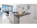 Modern kitchen with a large island and city views at 111 S Pineapple Ave # 605, Sarasota, FL 34236