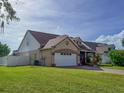Well-maintained home with a two-car garage, lush green lawn and attached side addition at 7209 49Th E Pl, Palmetto, FL 34221