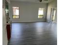 Large living room with gray vinyl plank flooring and lots of natural light at 7861 Pine Trace Dr # 7861, Sarasota, FL 34243