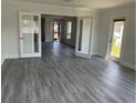 Spacious living room with gray vinyl plank flooring at 7861 Pine Trace Dr # 7861, Sarasota, FL 34243