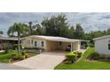 Cute yellow home with carport and nicely landscaped lawn at 8454 Imperial Cir, Palmetto, FL 34221