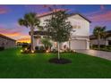 Two-story house with a gray-toned brick facade, landscaped lawn, and a paved driveway at 3717 Savanna Palms Ct, Lakewood Ranch, FL 34211