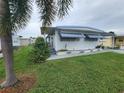 Single-wide manufactured home with landscaping at 5317 Chateau Ln, Bradenton, FL 34207