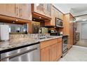 Modern kitchen features stainless steel appliances, light wood cabinetry, and granite countertops at 5855 Midnight Pass Rd # 319, Sarasota, FL 34242