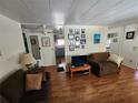 Living room with hardwood floors and view into kitchen at 5530 Denmark Dr, Bradenton, FL 34207
