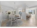 Elegant dining room with a round table and chandelier at 16706 Vardon Ter # 107, Bradenton, FL 34211