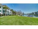 Waterfront condos with lush green lawn and tropical landscaping with boat docks and canal views at 4380 Exeter Dr # 303, Longboat Key, FL 34228