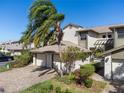 Exterior view of charming condo with two-car garage and well-manicured landscaping at 1712 Starling Dr # 101, Sarasota, FL 34231