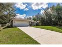 Front view of a single story house with a driveway and landscaping at 7432 Swartburg Rd, North Port, FL 34291