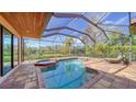 Relaxing pool and spa with screened enclosure, overlooking tranquil preserve views at 14636 Newtonmore Ln, Lakewood Ranch, FL 34202