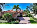 Stunning curb appeal with Mediterranean-style architecture and lush landscaping at 14636 Newtonmore Ln, Lakewood Ranch, FL 34202