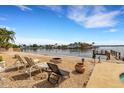 Relaxing backyard oasis with fire pit and waterfront views at 1903 Bayshore Dr, Belleair Beach, FL 33786