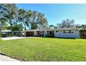 Charming ranch home with a modern facade and manicured lawn at 4616 Leeta Ln, Sarasota, FL 34234