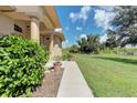 Side walkway of a one-story house with lush landscaping at 6930 69Th E St, Palmetto, FL 34221