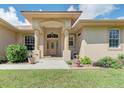 Front entrance of a one-story house with columns and landscaping at 6930 69Th E St, Palmetto, FL 34221