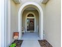 Inviting front entry with arched doorway and decorative wreath at 12715 Lake Silver Ave, Bradenton, FL 34211