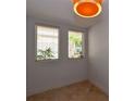 Bright room with tiled floor and two windows at 235 Cocoanut Ave # 113C, Sarasota, FL 34236