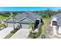 Aerial view of two-unit home with a pond nearby at 4133 Golden Creek Ter, Parrish, FL 34219