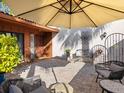 Relaxing patio with umbrella, seating, and brick pavers at 6417 Meadowlark Ln # 6417, Bradenton, FL 34210
