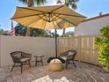 Outdoor patio area with seating and umbrella at 6417 Meadowlark Ln # 6417, Bradenton, FL 34210