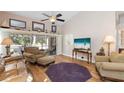 Bright living room with hardwood floors, comfortable seating, and sliding glass doors at 4966 Clubview E Ct, Bradenton, FL 34203