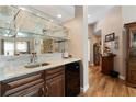 Home bar with granite countertop, sink, and wine cooler at 4966 Clubview E Ct, Bradenton, FL 34203