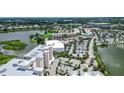 Aerial view of condo complex near shopping and a lake at 10520 Boardwalk Loop # 301, Bradenton, FL 34202