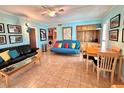Bright living room with sofa, futon, and dining table at 2850 Gulf Of Mexico Dr # 2, Longboat Key, FL 34228