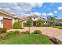 Attractive house featuring a three-car garage, well-manicured landscaping, and a brick driveway at 1111 143Rd Ne St, Bradenton, FL 34212