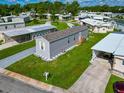Mobile home with landscaped lot in a 55+ community at 6421 Kilohee Ct, North Port, FL 34287